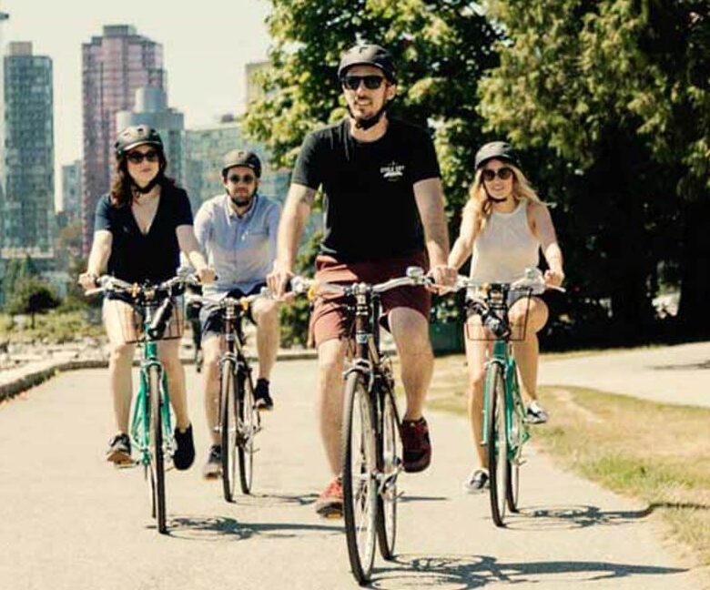 A knowledgeable guide and guests biking through Vancouver on The Grand Tour.