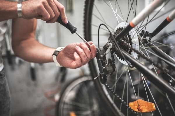 person servicing a bicycle