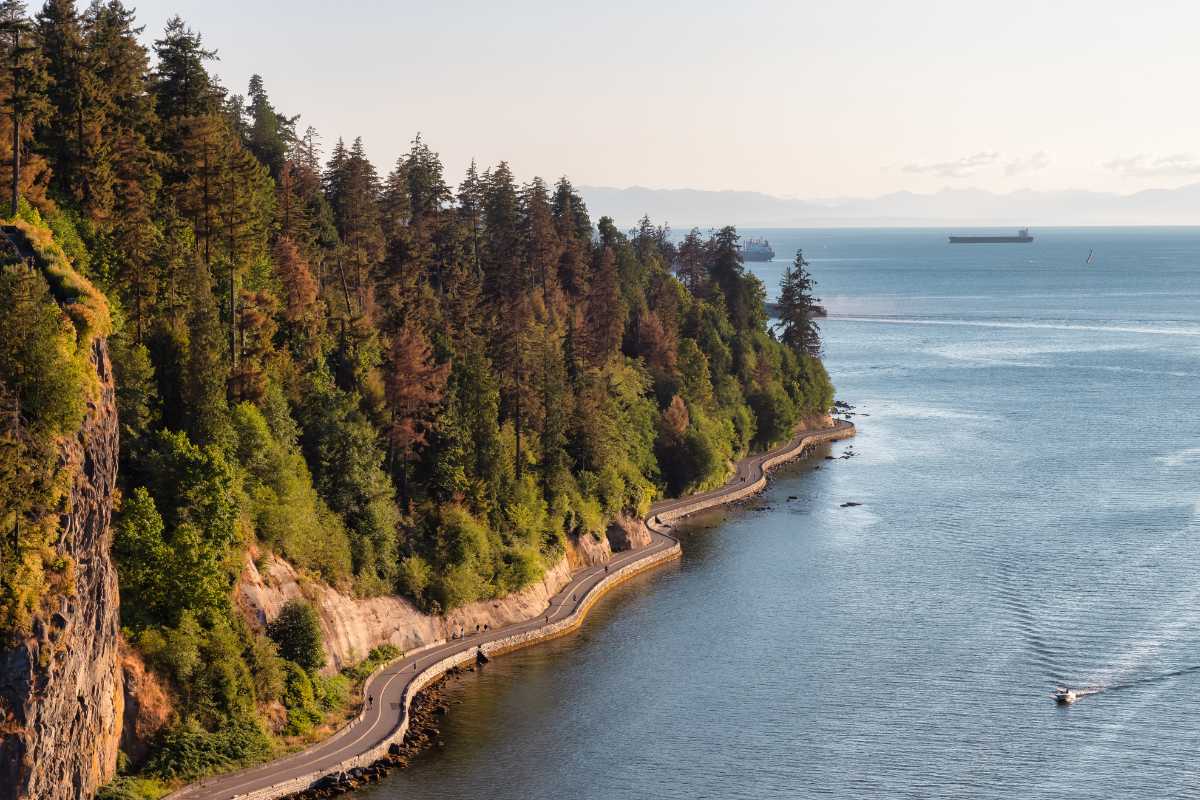 An aerial photo of Stanley Park and the seawall against the Burrard Inlet