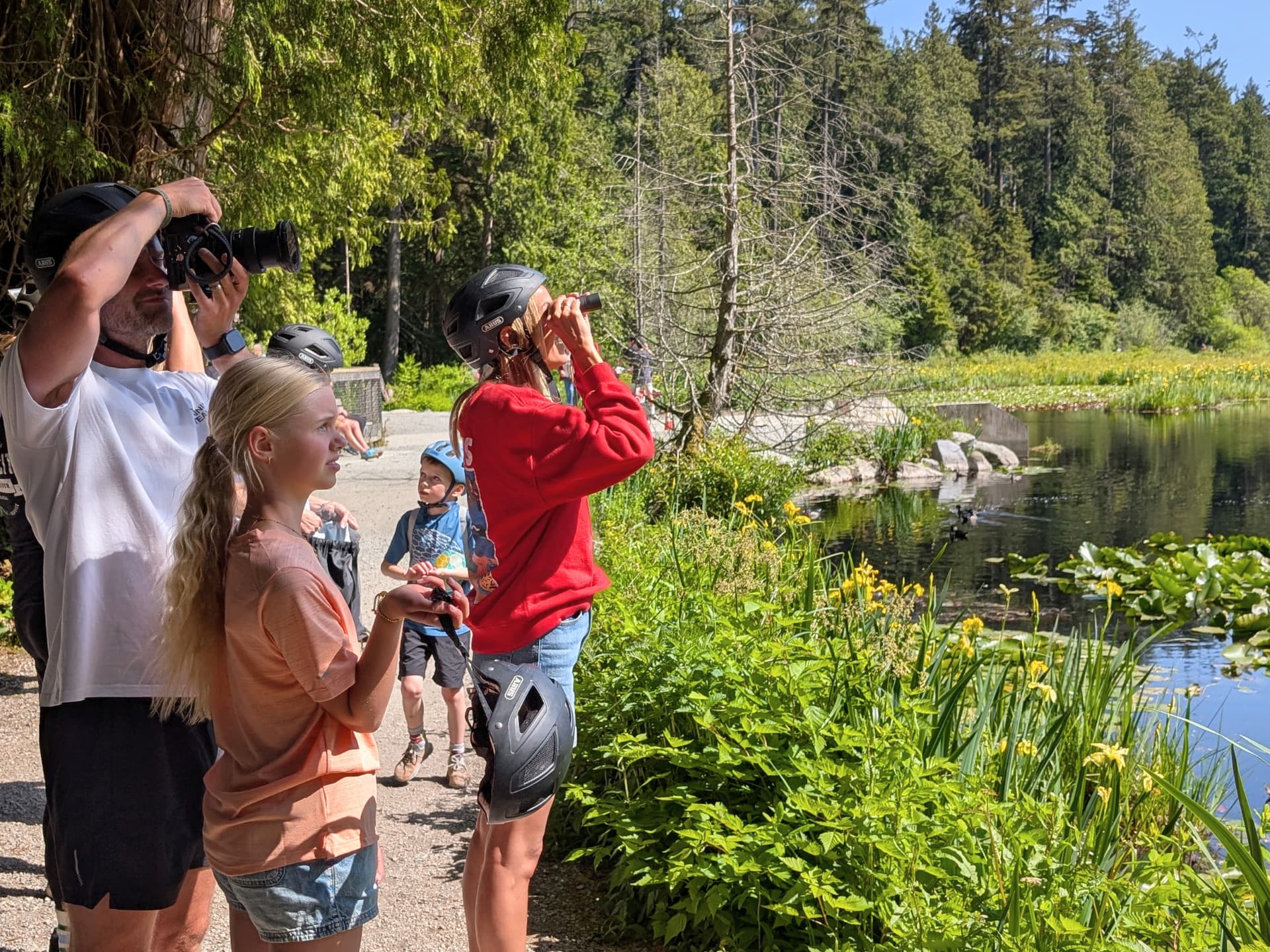 a family uses binoculars to see the wildlife in Stanley Park