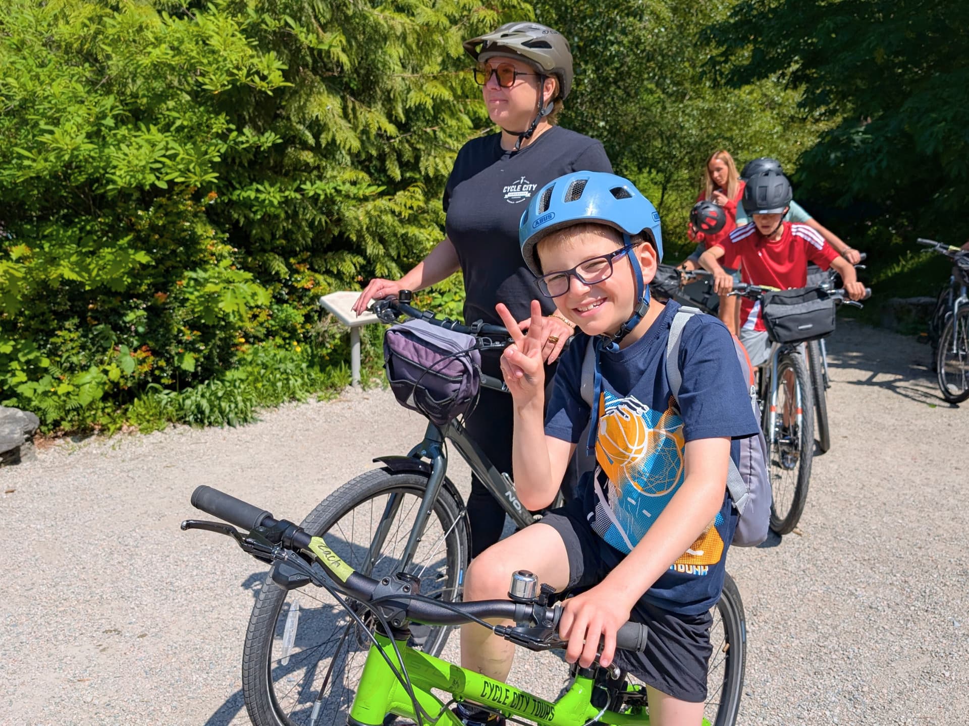 a child poses with his bike and the tour guide